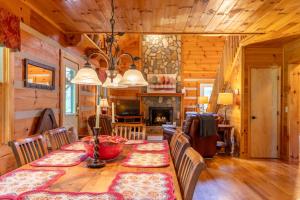a dining room with a table and a fireplace at Hemlock Hideaway in Boone