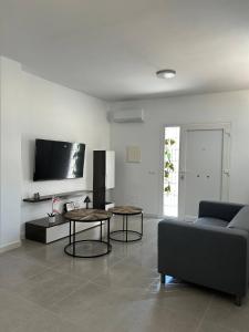 a living room with a couch and two tables at Acogedora Casa con terraza en Manilva in Manilva +14 photos