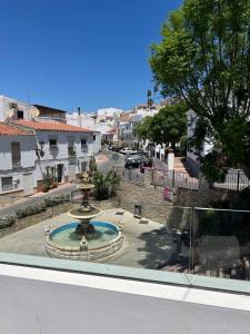 a fountain in the middle of a city street at Acogedora Casa con terraza en Manilva in Manilva