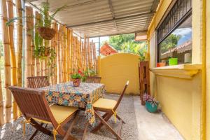 a patio with a table and chairs on a balcony at Casa Mandala by Dreamcatcher in Sarchí