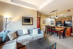 a living room with a couch and a table at Copper One 407 in Frisco