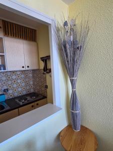 a blue vase sitting on a table in a kitchen at Studio 11 pour 4 personnes in Saint-Honoré