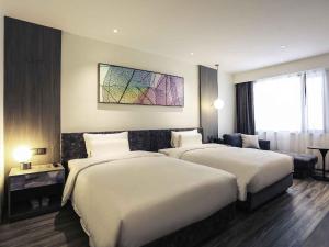 Ένα ή περισσότερα κρεβάτια σε δωμάτιο στο Mercure Shanghai Hongqiao South