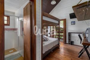 um quarto em uma casa com uma cama e um banheiro em Suíte Front Paraíso dos Ciclistas em Gramado