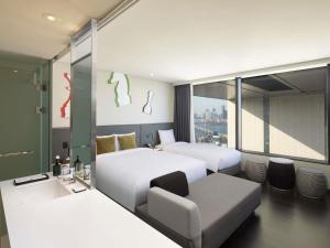 a hotel room with two beds and a couch at ibis Styles Ambassador Seoul Yongsan in Seoul +75 photos