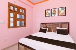 a bedroom with a large bed in a room at Hotel O SK in Sītāpur +21 photos