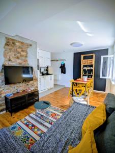 a living room with a couch and a tv at Kopaonička priča in Kopaonik