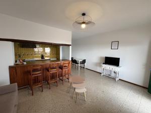 a kitchen with a bar and a table and chairs at Vista Paraiso in Tías