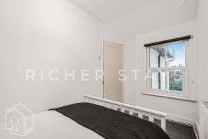 Ένα ή περισσότερα κρεβάτια σε δωμάτιο στο Homely 3-Bedroom Retreat with Garden & Living Room