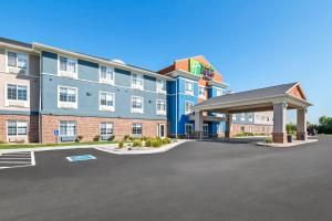 a rendering of the front of a hotel with a parking lot at Holiday Inn Express Hotel & Suites Council Bluffs - Convention Center Area by IHG in Council Bluffs