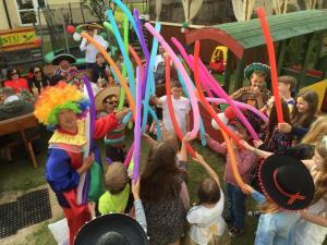 a group of children in clown costumes holding up colored ribbons at Dworek Karwia u Ewy Wiosenna 10 in Karwia