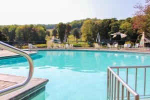 a large swimming pool with blue water at The Highlands at Harbor Springs in Harbor Springs