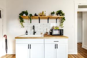a kitchen with white cabinets and a sink at Short North Convention Private Parking Pets! in Columbus +116 photos