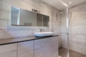 a bathroom with a sink and a mirror at Superbe villa 3 chambres – Piscine & 2 pièces in Biot +24 photos