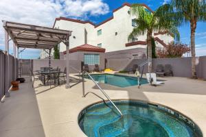 a swimming pool in the backyard of a house at Best Western Gold Poppy Inn in Tucson