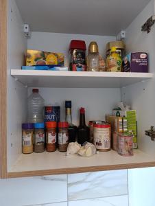 a refrigerator shelf filled with lots of food items at résidence KAKIKA in Verviers