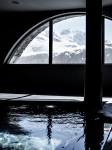 a window in a room with water in front of it at Le Val Thorens, a Beaumier hotel in Val Thorens