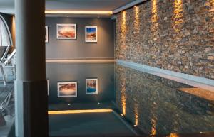 a room with pictures on the wall and a pool at Le Val Thorens, a Beaumier hotel in Val Thorens