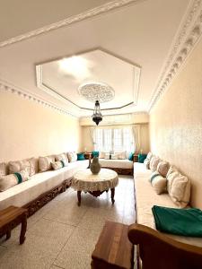 a large living room with couches and a table at Résidence familiale Agadir, 15 mins de la plage in Agadir