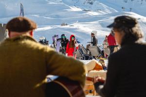 a group of people standing on a ski slope at Le Fitz Roy, a Beaumier hotel in Val Thorens