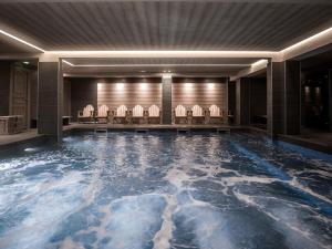 ヴァル・トランスにあるLe Fitz Roy, a Beaumier hotelのホテルロビーのスイミングプール(椅子付)