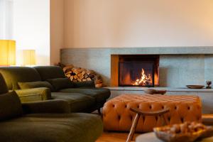 a living room with couches and a fireplace at Grand Hotel Belvedere, a Beaumier Hotel in Wengen