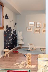 een kinderkamer met een speelhoek met een konijntje aan de muur bij L'Alpaga, a Beaumier hotel in Megève
