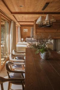 a living room with a table and chairs and a couch at L'Alpaga, a Beaumier hotel in Megève