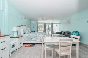 a bedroom with a bed and a table and chairs at Cedar Key Florida Condo at Park Place in Cedar Key