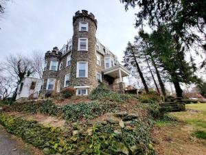 a large brick building on top of a hill at Style and Charm 2BR apt in Melrose Park in Elkins Park