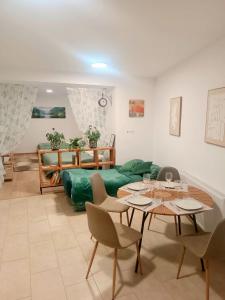a living room with a green couch and a table at Family Apartments Tauchen in Mönichkirchen