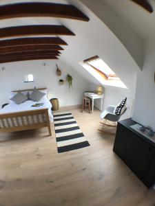 a bedroom with a bed and a desk in a attic at The Net Loft in Anstruther
