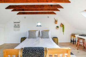 a bedroom with a bed in a room with wooden ceilings at The Net Loft in Anstruther