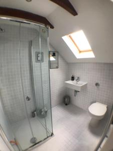 a bathroom with a shower and a toilet and a sink at The Net Loft in Anstruther +32 photos