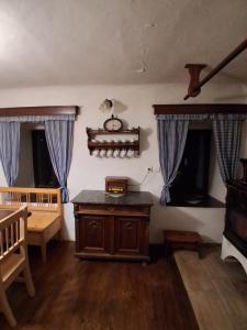 a room with a wooden table and two windows at Chalupa Vagner, Pernek in Horní Planá