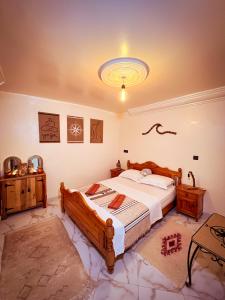 a bedroom with a bed and a chandelier at Vagusta Surf House in Agadir +23 photos