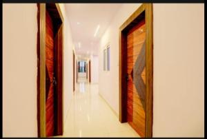un pasillo con puertas de madera en una casa en Savoygrandluxuryrooms, en Warangal