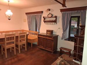 a living room with a dining room table and a dining room at Chalupa Vagner, Pernek in Horní Planá