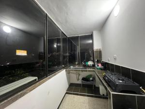 a black and white bathroom with a sink at APARTAMENTO ESTADIO in Cali