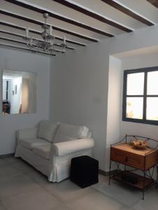 a living room with a white couch and a table at Casa rural Ismael in El Acebrón