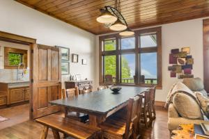 a kitchen and dining room with a table and chairs at Cardinal Perch in Beech Mountain