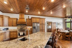 a kitchen with wooden cabinets and a large counter top at Cardinal Perch in Beech Mountain
