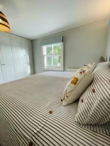 a bedroom with a bed with two pillows on it at Harbour House Bristol Entire townhouse with harbour views, sleeps up to 7 people in Bristol