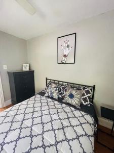 a bedroom with a bed with pillows on it at Your Home Away From Home in Melrose Park