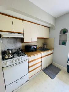 a kitchen with a stove and a sink at Your Home Away From Home in Melrose Park