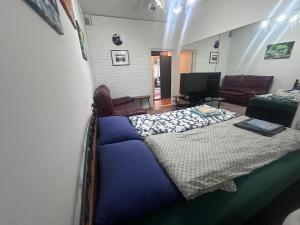 a bedroom with a large bed and a living room at dream room in Helsinki