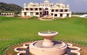 a large house with a large fountain in front of it at Rajasthali Resort & Spa in Jaipur