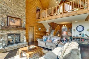 a living room with a couch and a fireplace at Hike, Fish and More Grand Cabin with Decks in Sturgis in Crook City