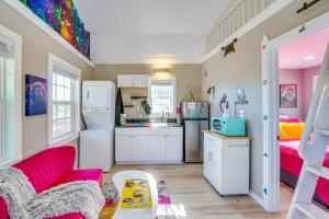 a kitchen with white appliances and pink furniture at Galactikitty - Quirky Cabin Near Lake Brownwood! in Lake Brownwood