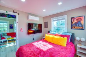a bedroom with a large bed with colorful pillows at Galactikitty - Quirky Cabin Near Lake Brownwood! in Lake Brownwood